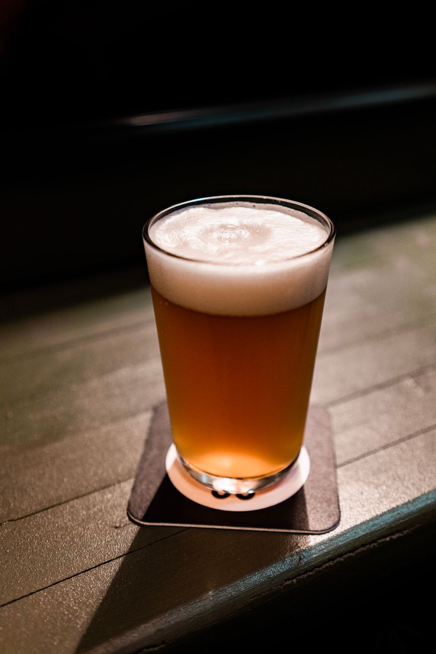 close up photo of beer in a drinking glass
